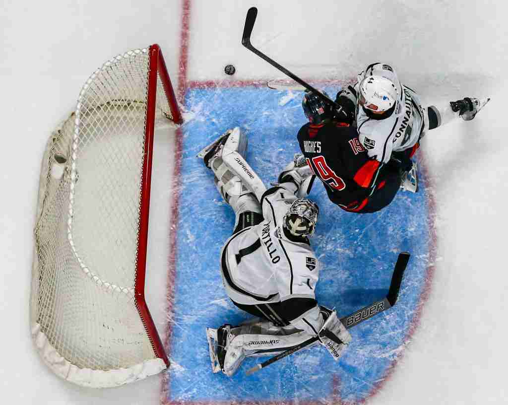 Coachella Valley forward Cameron Hughes (19) looks for a shot on Ontario goaltender Erik Portillo (1) as defenseman Kevin Connauton (44) checks him into the net during the first period of Game 2 of the Pacific Division Finals at Acrisure Arena in Palm Desert, Calif., Friday, May 17, 2024.