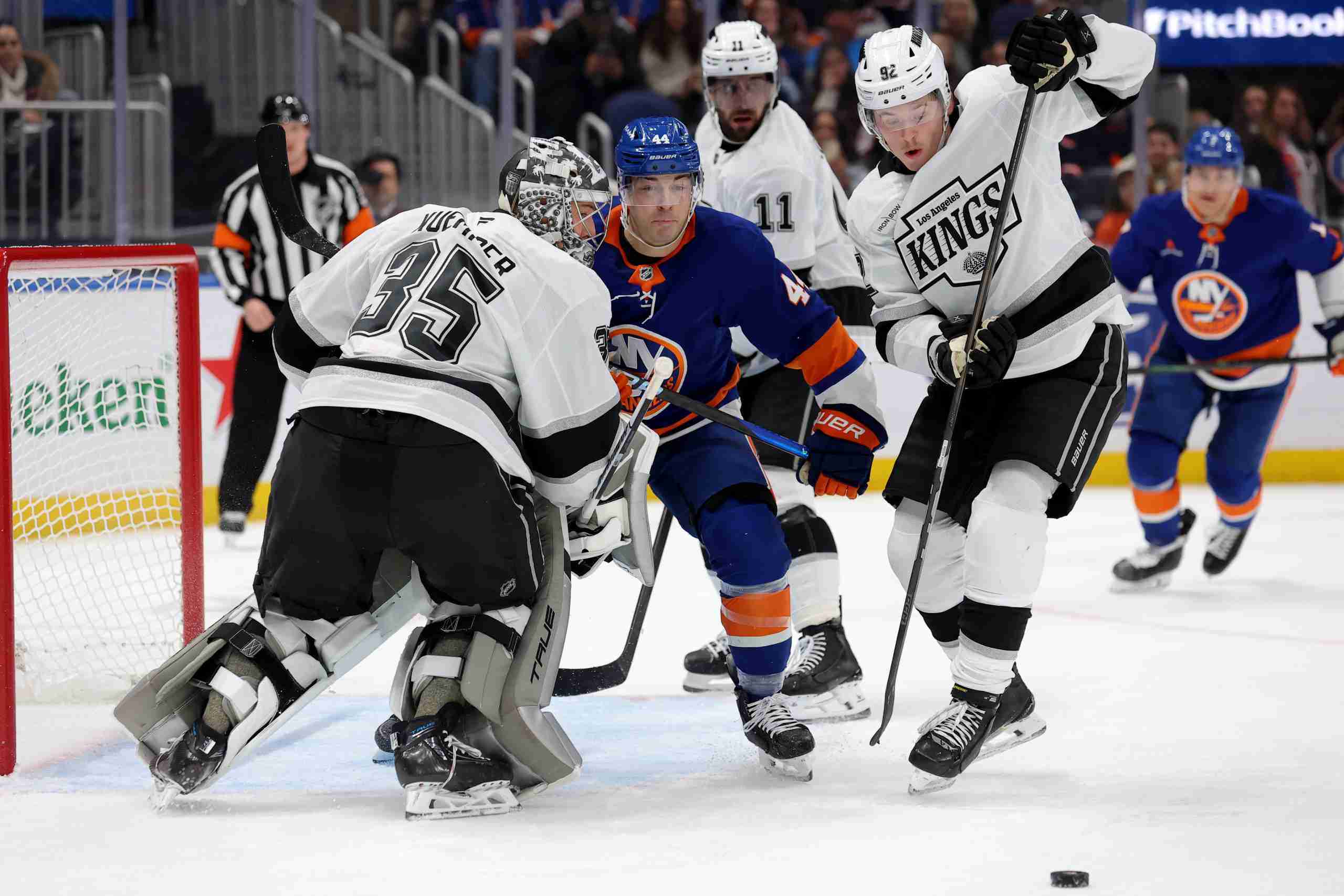 Dec 10, 2024; Elmont, New York, USA; New York Islanders center Jean-Gabriel Pageau (44) fights for the puck against Los Angeles Kings goaltender Darcy Kuemper (35) and defenseman Brandt Clarke (92) during the second period at UBS Arena. Mandatory Credit: Brad Penner-Imagn Images