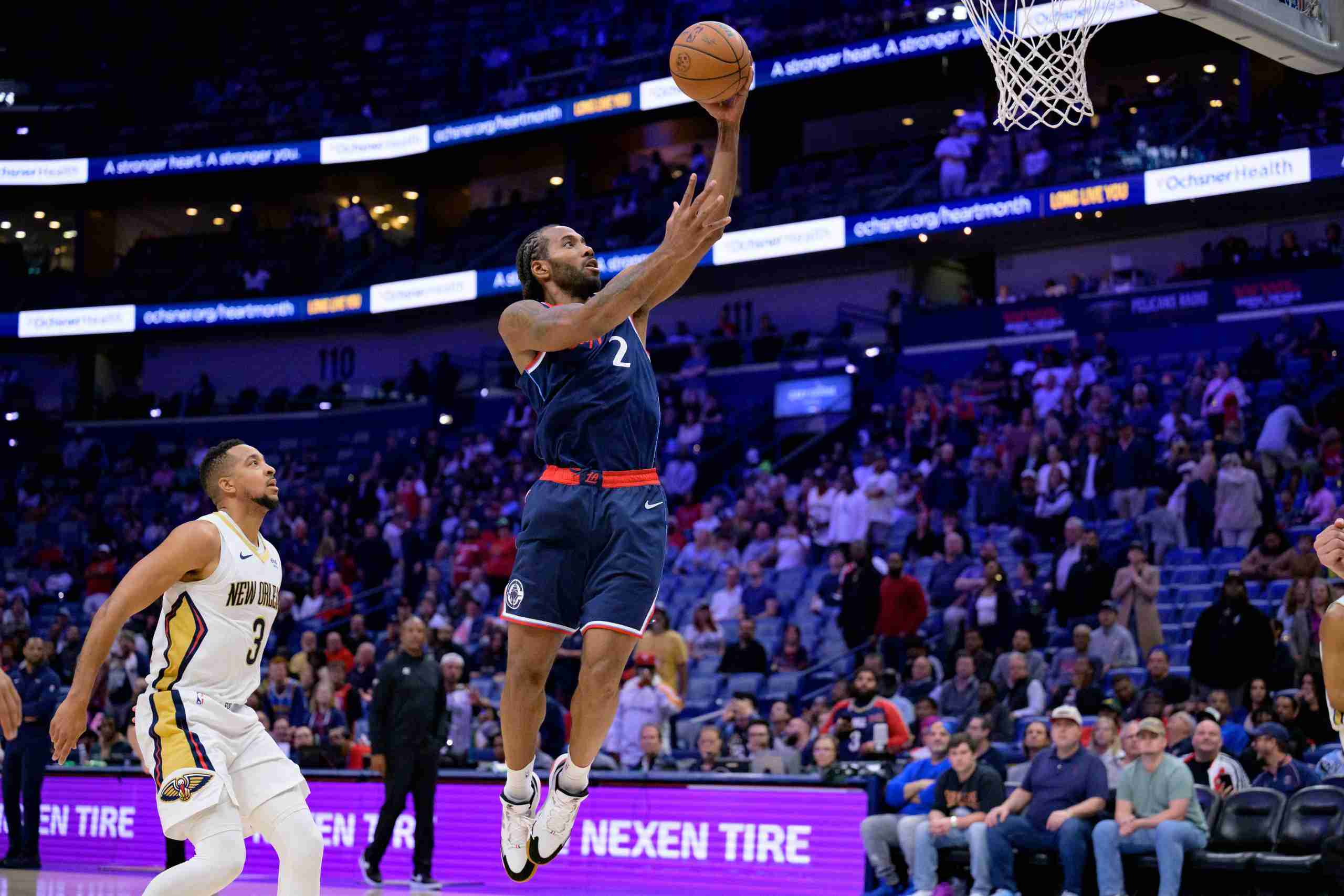 Mar 11, 2025; New Orleans, Louisiana, USA; Los Angeles Clippers forward Kawhi Leonard (2) shoots against New Orleans Pelicans guard CJ McCollum (3) during the second half at Smoothie King Center. Mandatory Credit: Matthew Hinton-Imagn Images