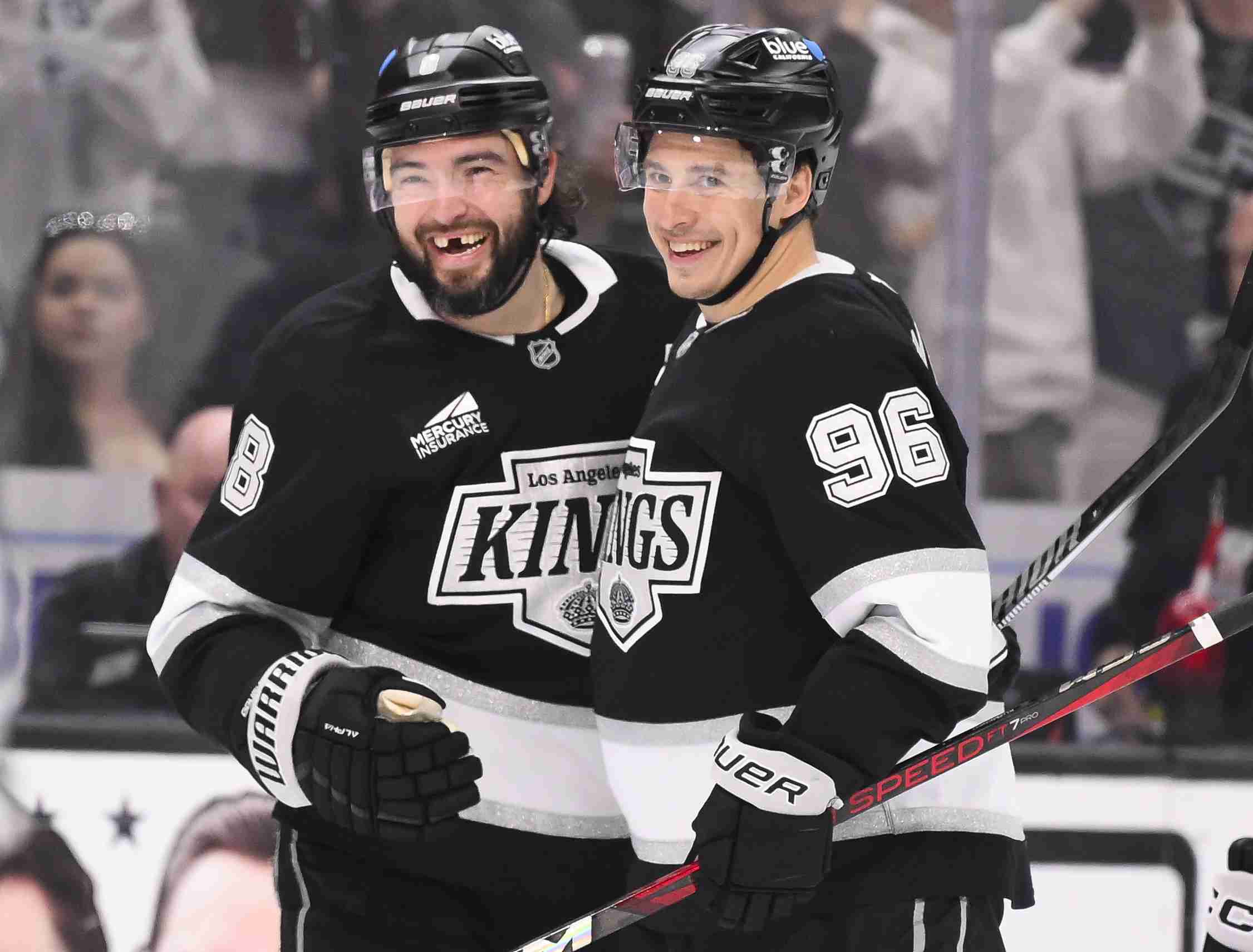 Apr 5, 2025; Los Angeles, California, USA; Los Angeles Kings defenseman Drew Doughty (8) and Los Angeles Kings left wing Andrei Kuzmenko (96) are all smiles after KuzmenkoÕs goal in the second period against the Edmonton Oilers at Crypto.com Arena. Mandatory Credit: Robert Hanashiro-Imagn Images
